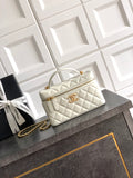 Chanel quilted handbag in light cream with top handles and gold chain strap