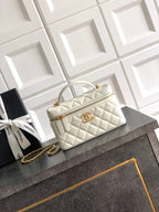 Chanel quilted handbag in light cream with top handles and gold chain strap