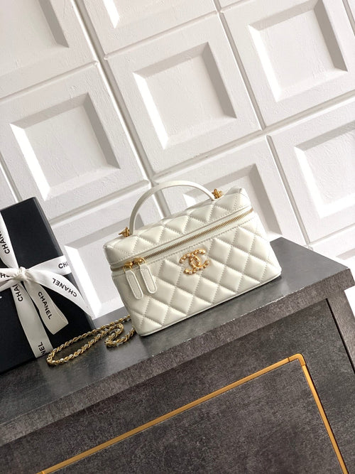 Chanel quilted handbag in light cream with top handles and gold chain strap