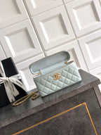 Light blue Chanel quilted bag with gold zipper and structured top handle