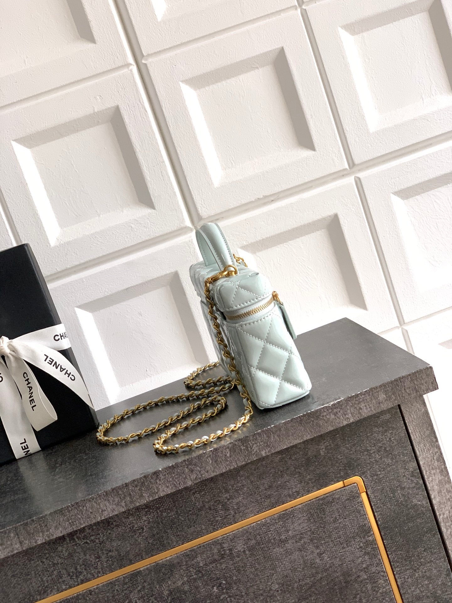 Light blue Chanel mini quilted bag with gold chain strap and top handle