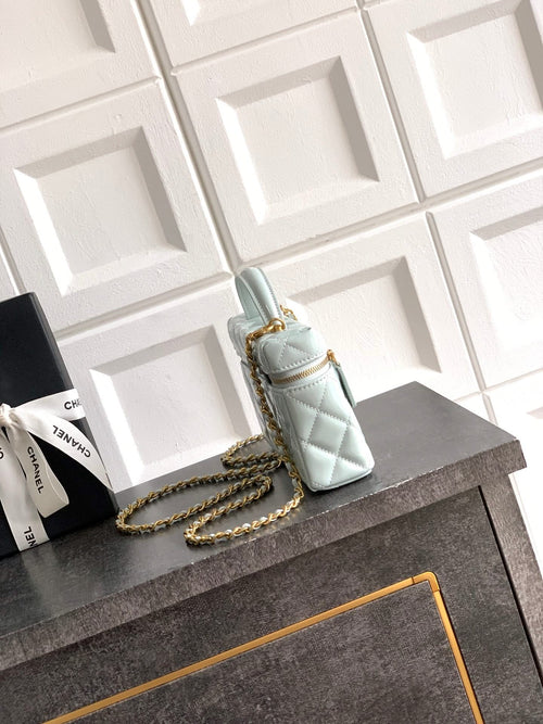Light blue Chanel mini quilted bag with gold chain strap and top handle