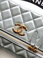 Light blue quilted Chanel bag with gold CC turn-lock and zip detail