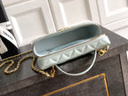 Light blue Chanel quilted clutch-style bag with gold chain and top handle