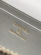 Chanel embossed leather interior label on light silver-gray bag