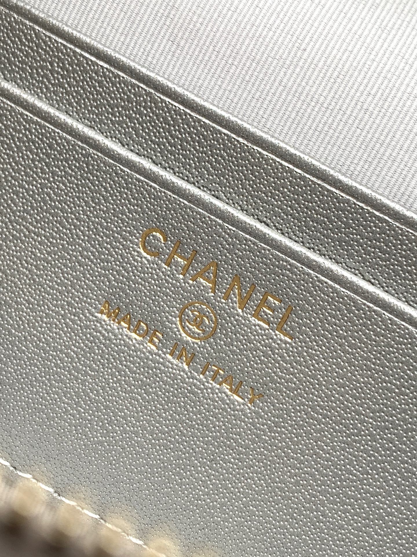 Chanel embossed leather interior label on light silver-gray bag