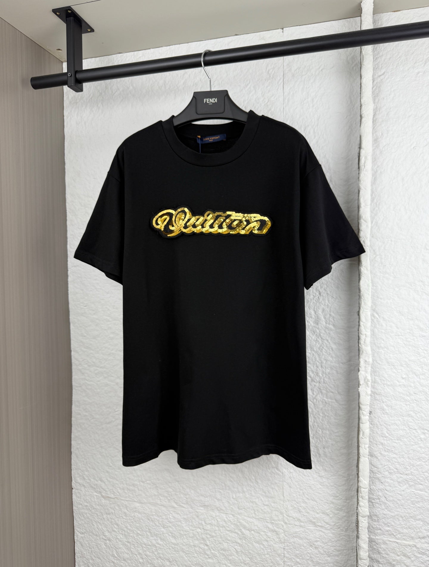 Louis Vuitton black short-sleeve T-shirt with gold embroidered “Quiltn”-style logo on chest