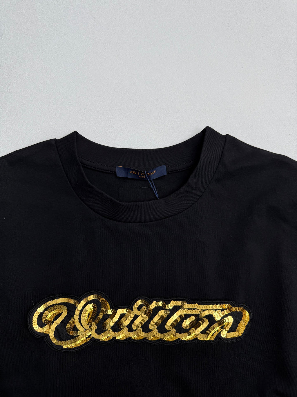 Louis Vuitton black short-sleeve T-shirt with large gold sequin-style chest logo