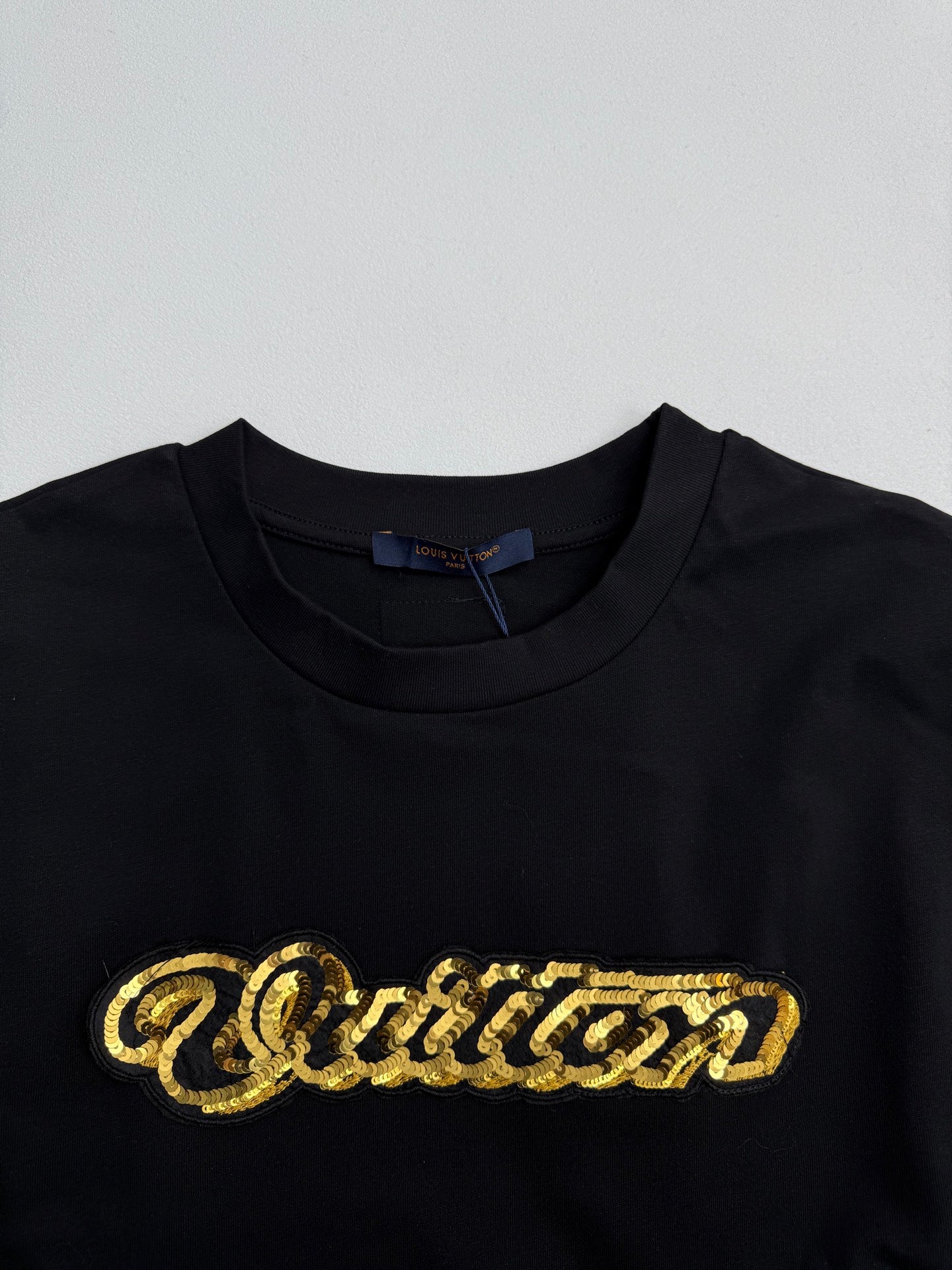 Louis Vuitton black short-sleeve T-shirt with large gold sequin-style chest logo