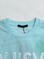 Louis Vuitton T-shirt neckline in light turquoise with brand label at collar.