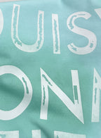 Louis Vuitton front lettering on light turquoise T-shirt, close-up typography.