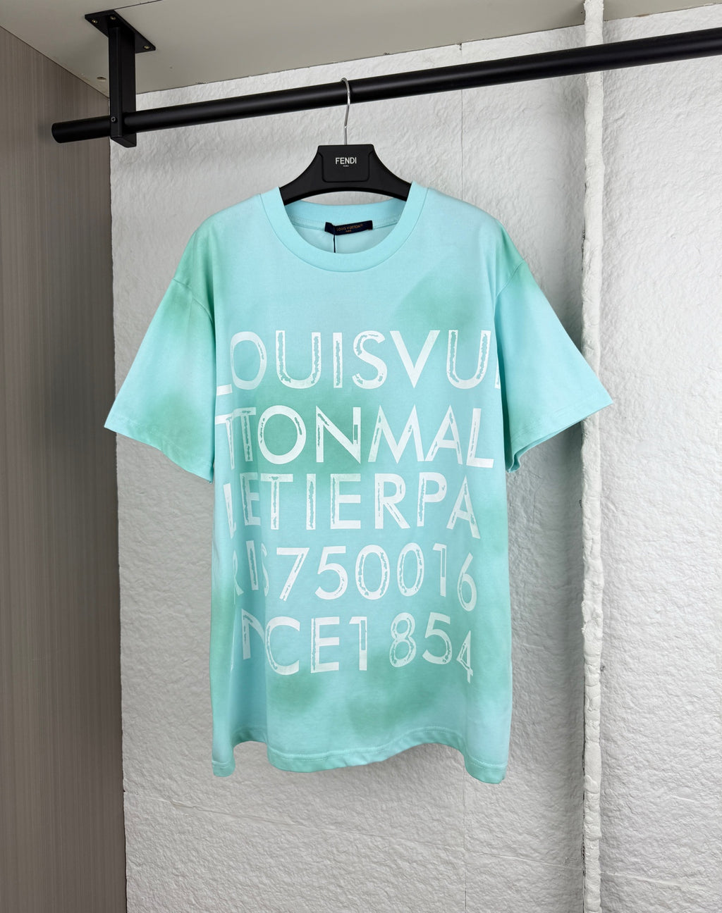Louis Vuitton graphic T-shirt, light turquoise, large front lettering.