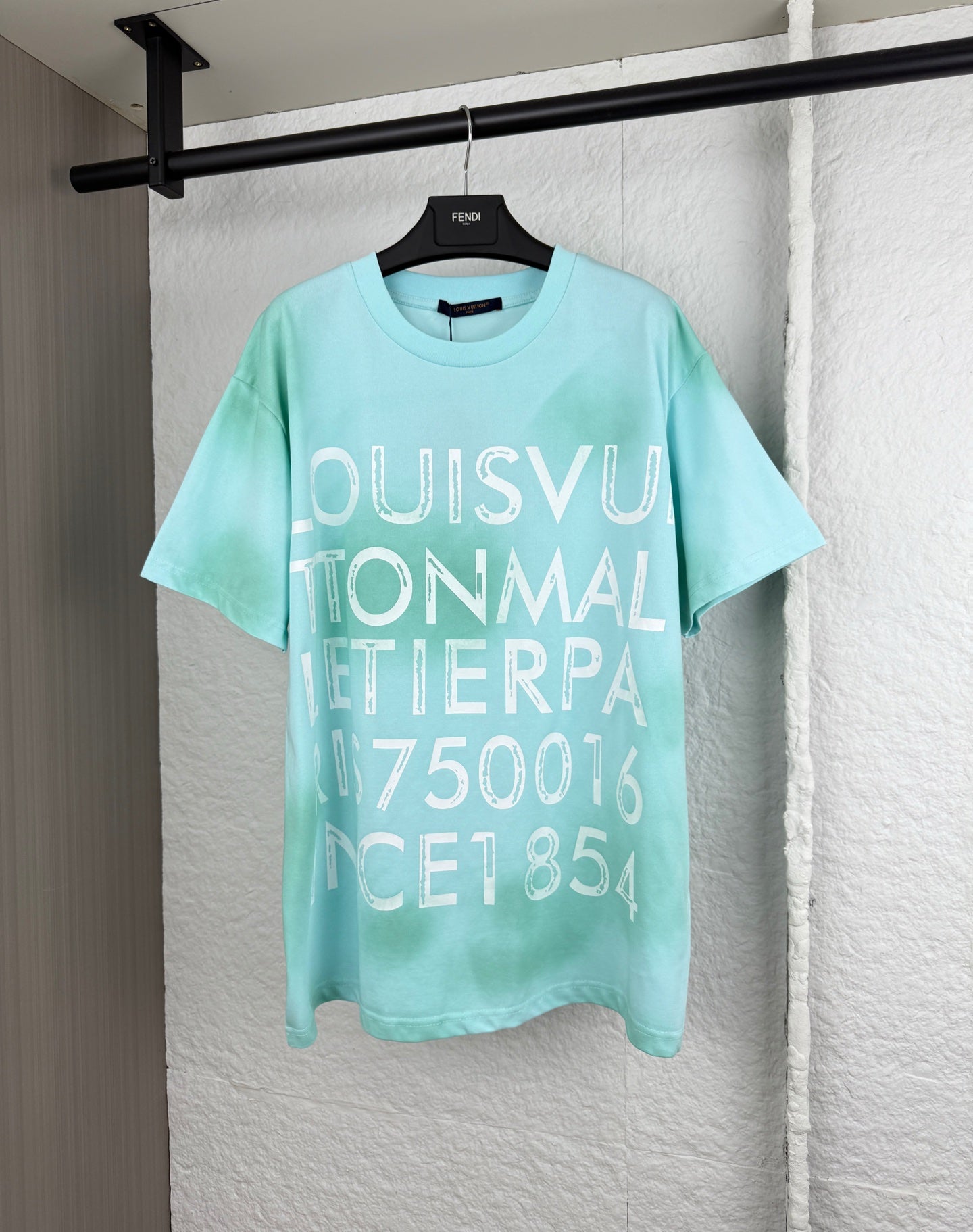 Louis Vuitton graphic T-shirt, light turquoise, large front lettering.