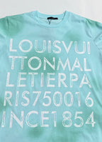Louis Vuitton T-shirt in light turquoise with large 'LOUISVUITTON' lettering.