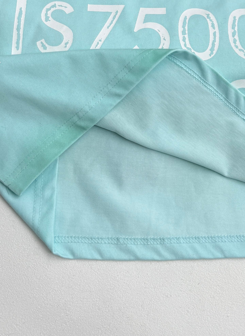 Louis Vuitton T-shirt fabric fold in light turquoise with stitched hem edge.