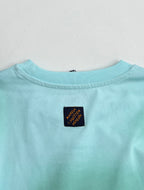 Louis Vuitton T-shirt back neckline in light turquoise with small logo label.