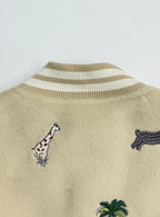 Beige jacket back with striped rib collar and embroidered animal motifs including zebra and dog.