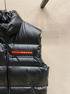 Black hooded puffer vest front panel with PRADA label on chest pocket.