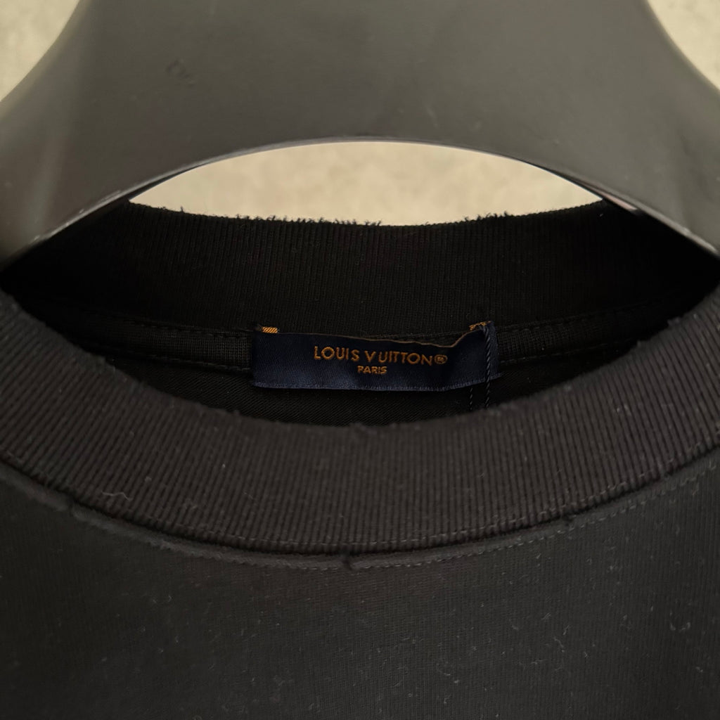 Black T-shirt collar with Louis Vuitton Paris brand label.