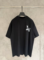 Black T-shirt with small white graphic logo on chest.