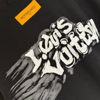 Black T-shirt with large white graffiti-style graphic and yellow tag.