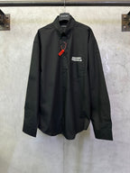 Balenciaga long-sleeve shirt, dark black with button front and chest logo patch.