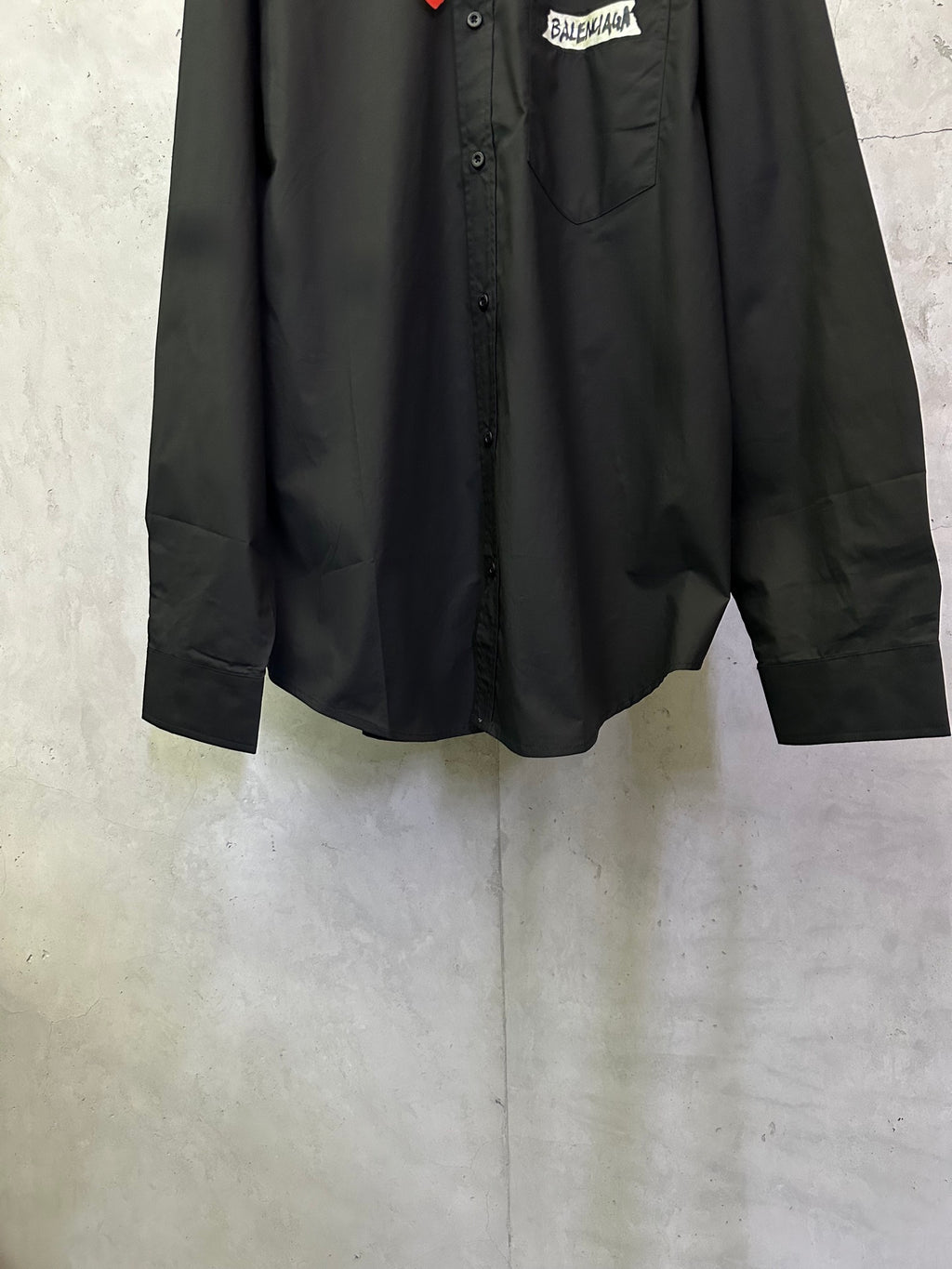 Balenciaga long-sleeve shirt, black, front lower section with visible pocket and buttons