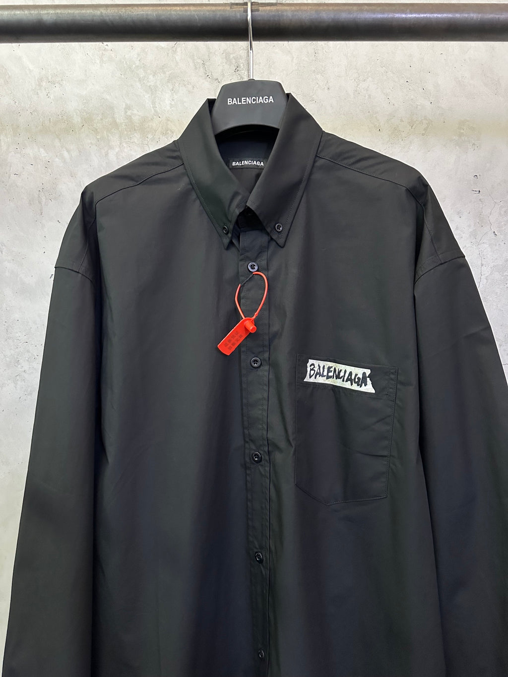 Balenciaga long-sleeve button-up shirt with front buttons, chest pocket, and logo patch