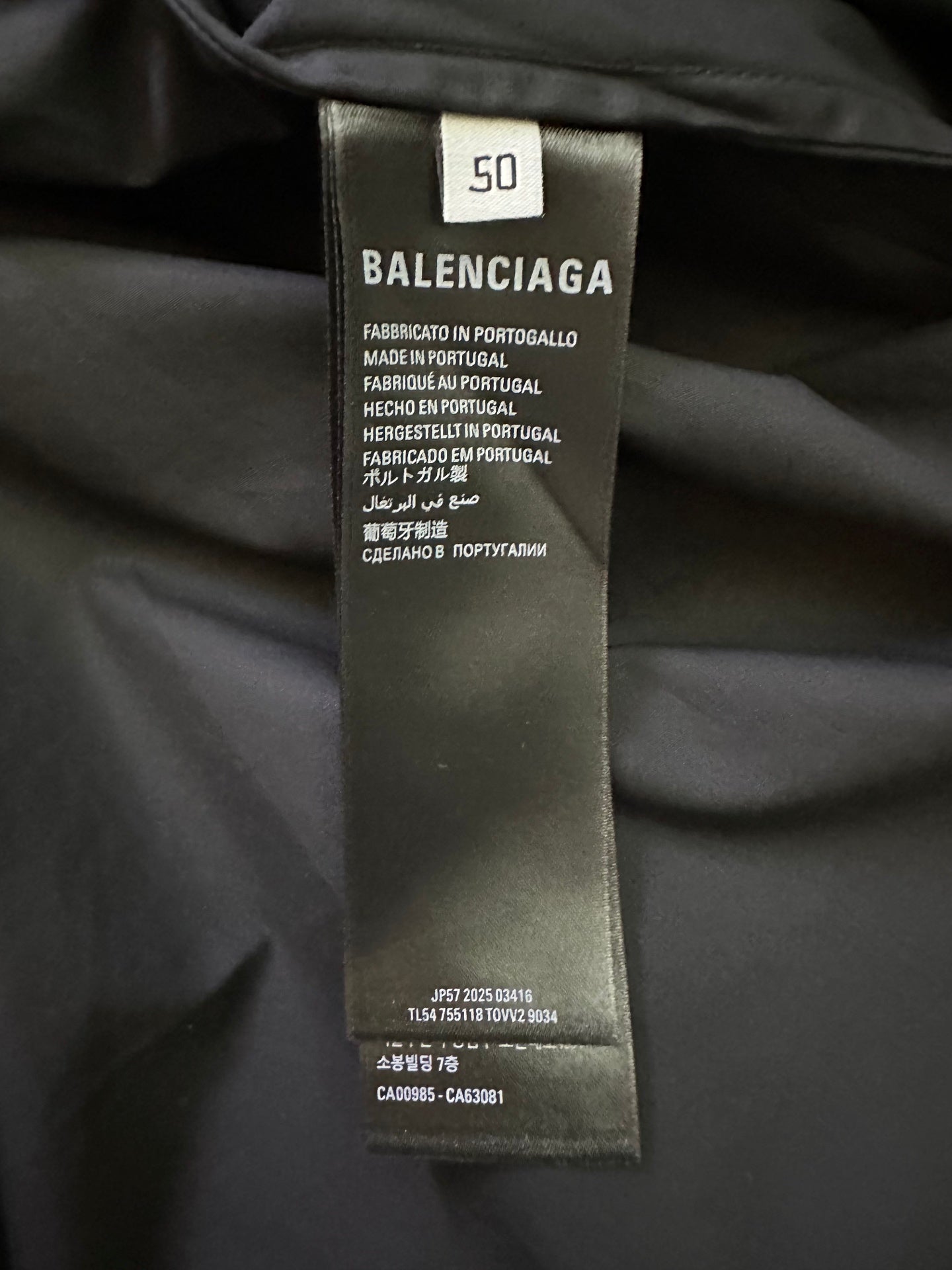 Balenciaga size and care label on dark black garment.