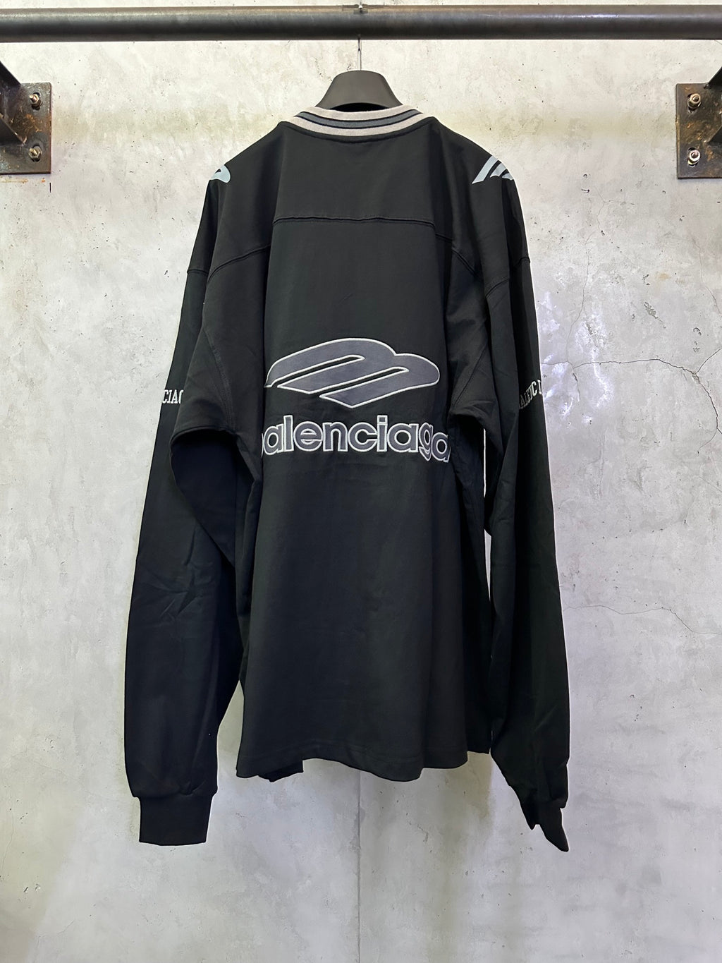 Black Balenciaga long-sleeve top, back view, with large central logo graphic