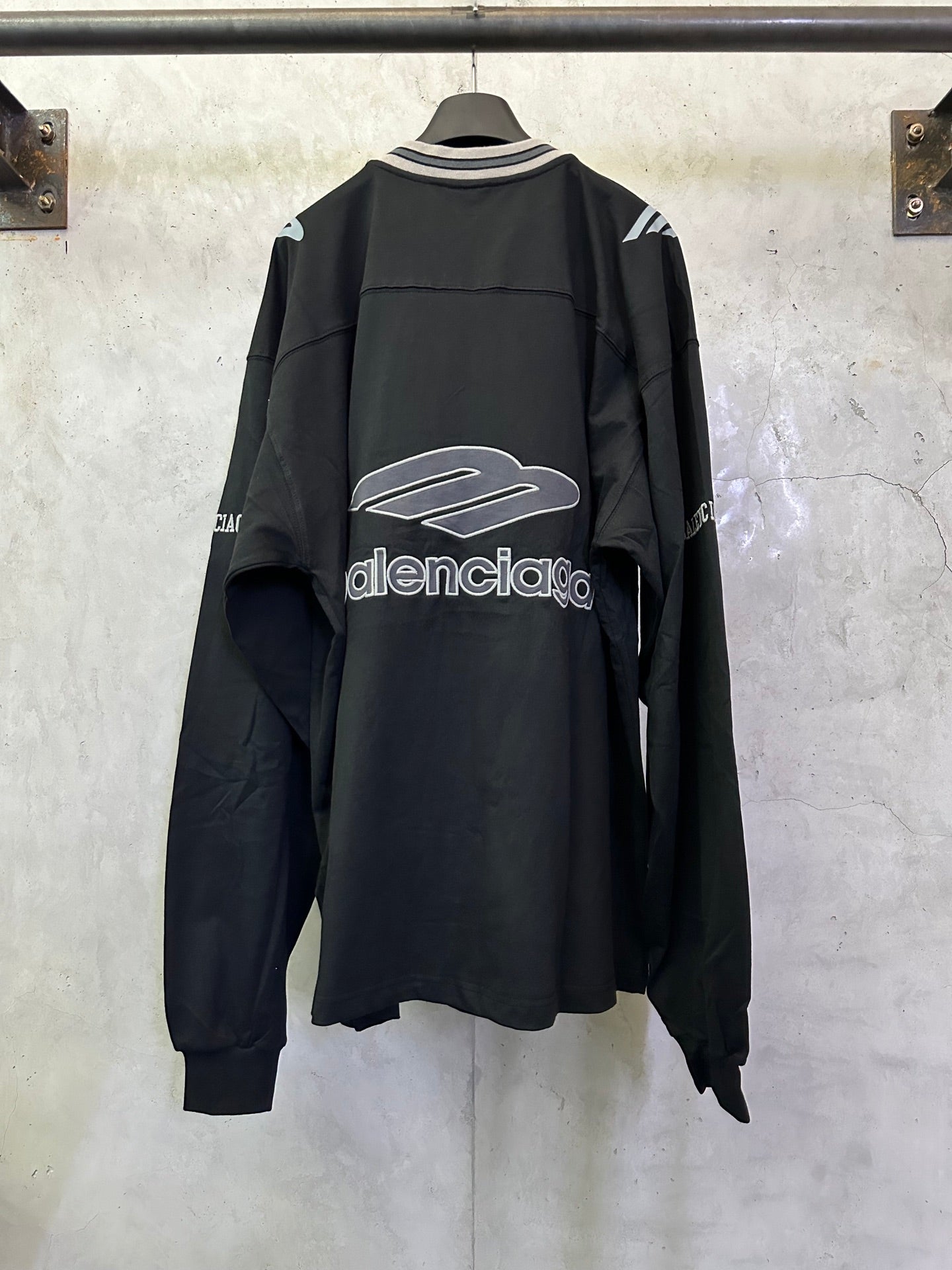 Black Balenciaga long-sleeve top, back view, with large central logo graphic