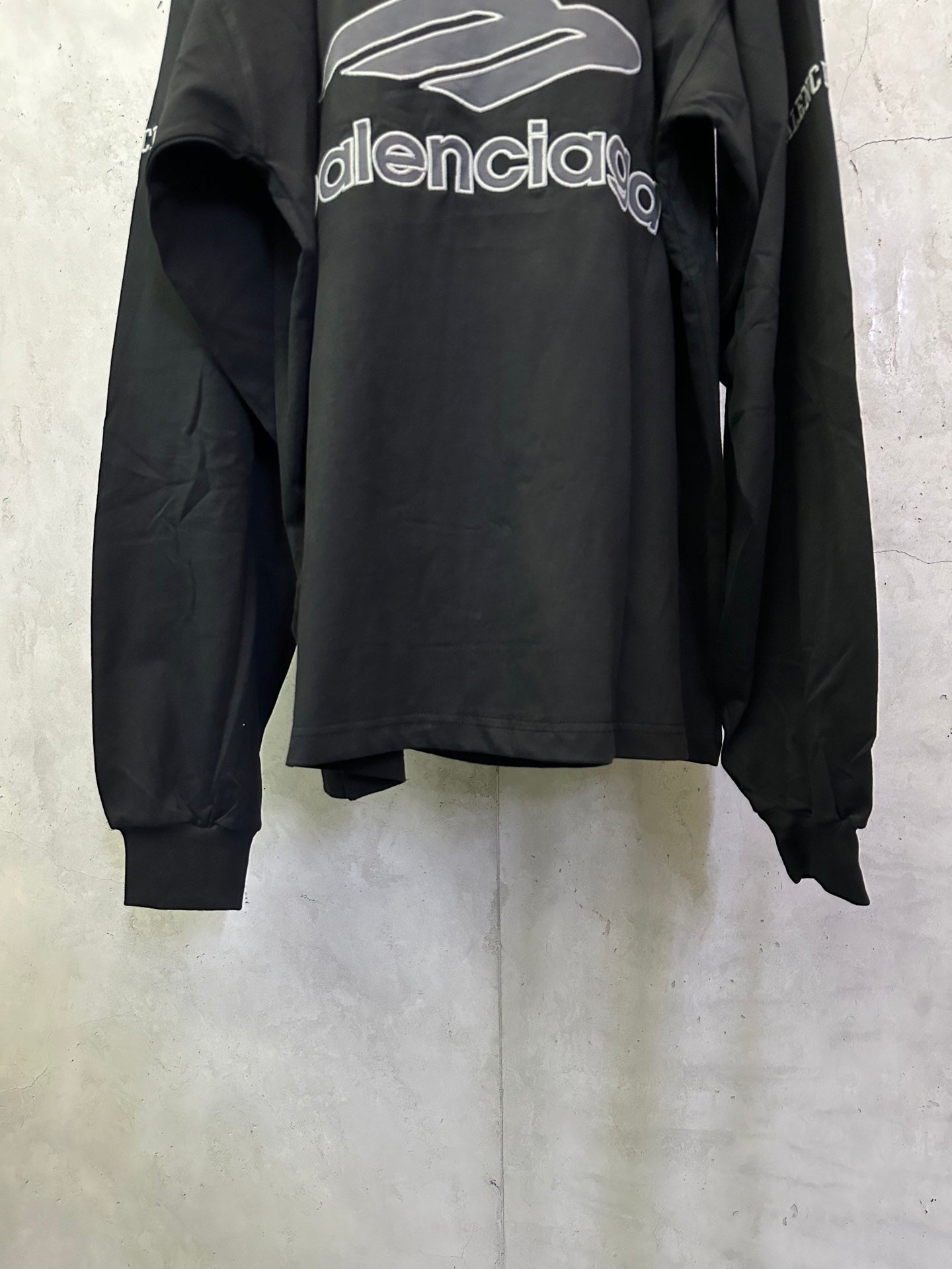 Black Balenciaga long-sleeve top back view with large Balenciaga logo graphic