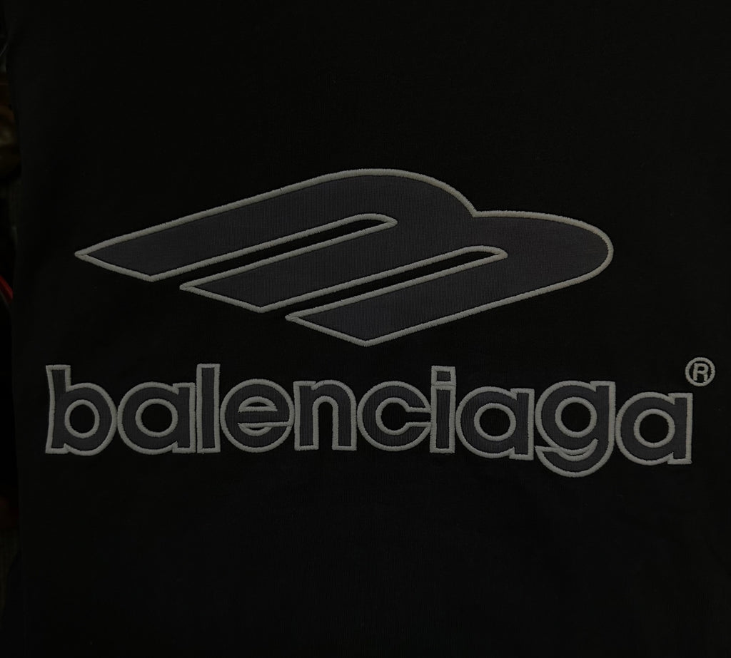 Black Balenciaga logo graphic on long-sleeve top, close-up