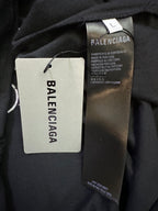 Balenciaga clothing label tag on dark fabric with size info and barcode