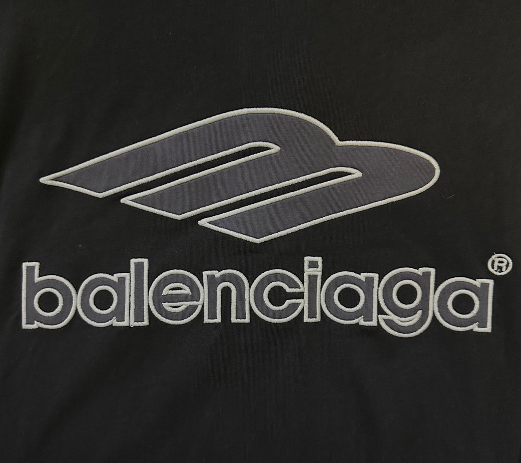 Balenciaga black short-sleeve jersey close-up of white 'balenciaga' logo print