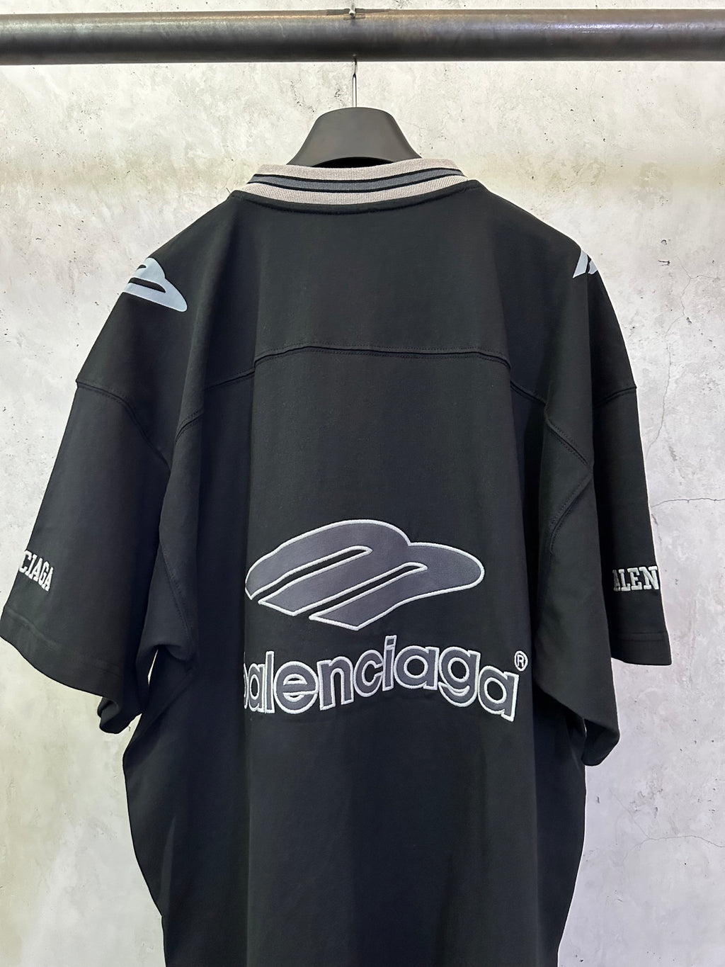 Balenciaga black short-sleeve jersey back with centered white logo and logo marks on sleeves