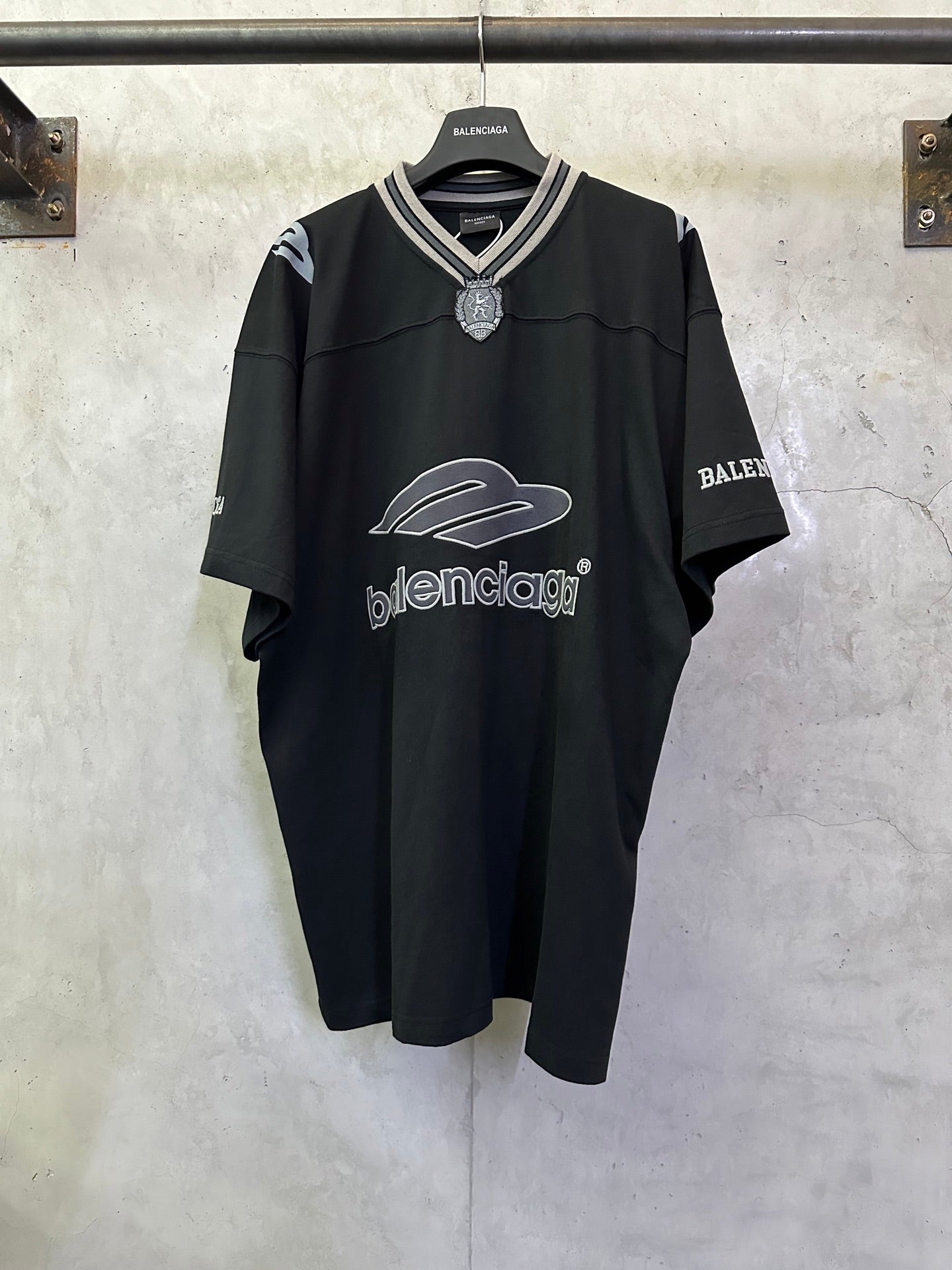 Balenciaga black short-sleeve V-neck jersey with white logo print and neck embellishment