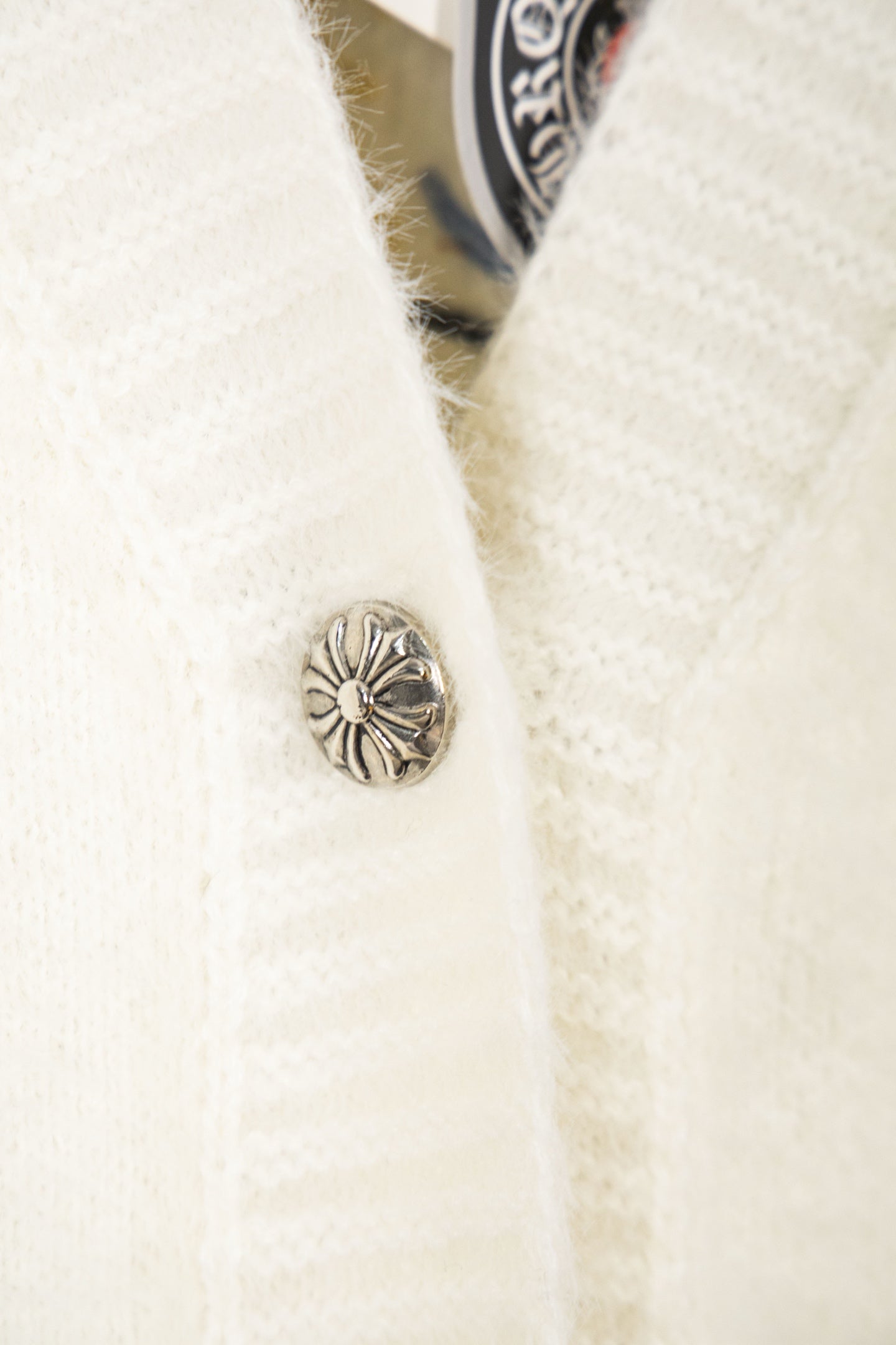 Cream cardigan with metal button detail on the front placket