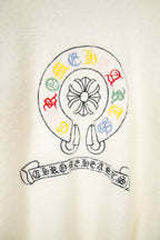 Cream knit cardigan with circular emblem and multicolor crest lettering