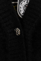 Black long garment with small chrome emblem detail