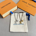 Louis Vuitton charm necklace set on white pouch with LV and star pendants