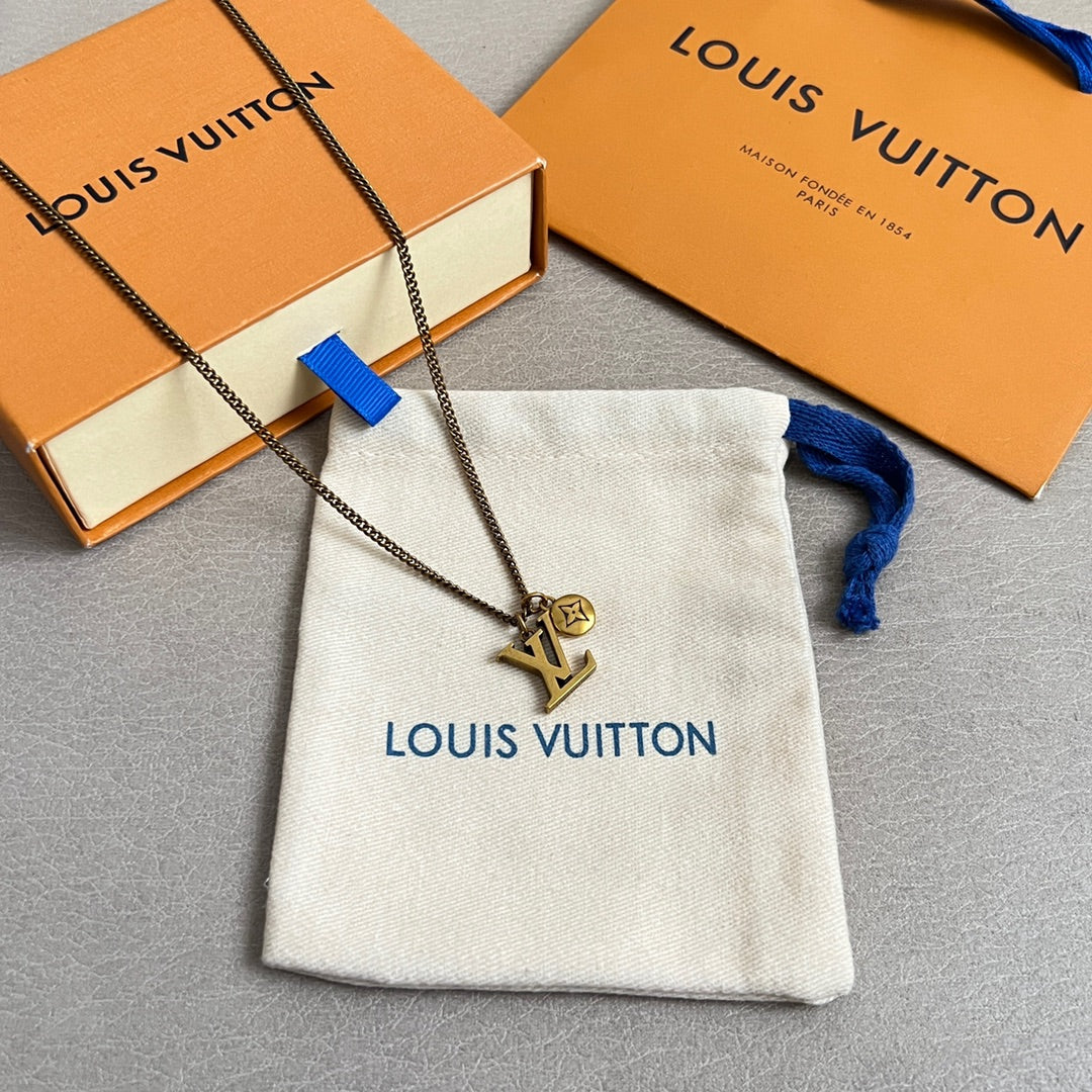 Louis Vuitton charm necklace with LV pendant, shown with white pouch