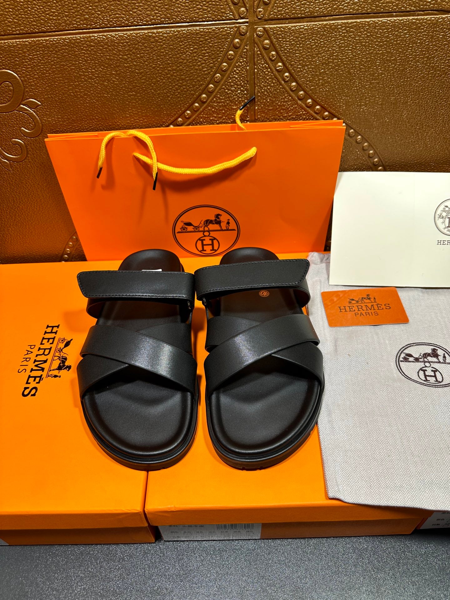 Black leather sandals with two wide cross straps and buckle detail