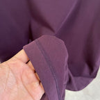 Louis Vuitton T-shirt sleeve edge detail in dark purple held in hand