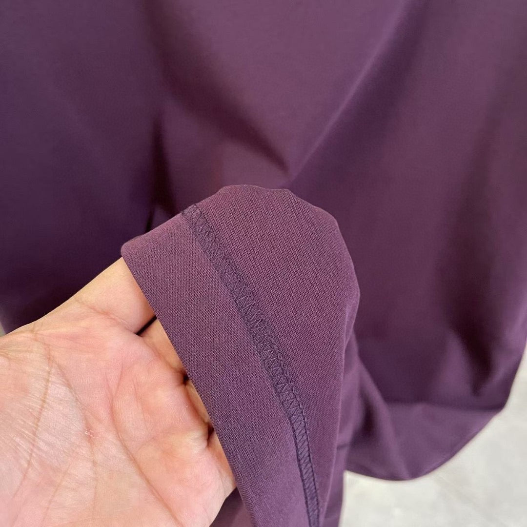 Crewneck T-shirt fabric close-up, deep purple sleeve seam