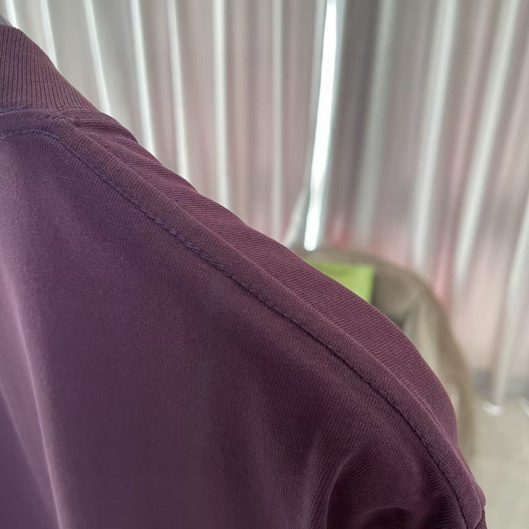 Louis Vuitton dark purple T-shirt shoulder and sleeve seam detail.