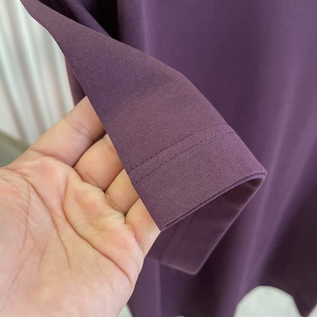 Louis Vuitton T-shirt sleeve hem in dark purple held in hand