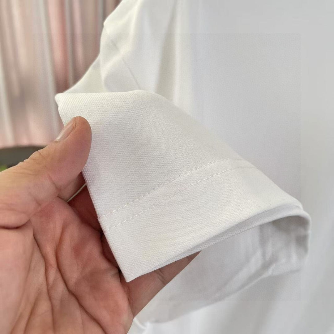 White Louis Vuitton T-shirt sleeve cuff and hem seam, held by hand