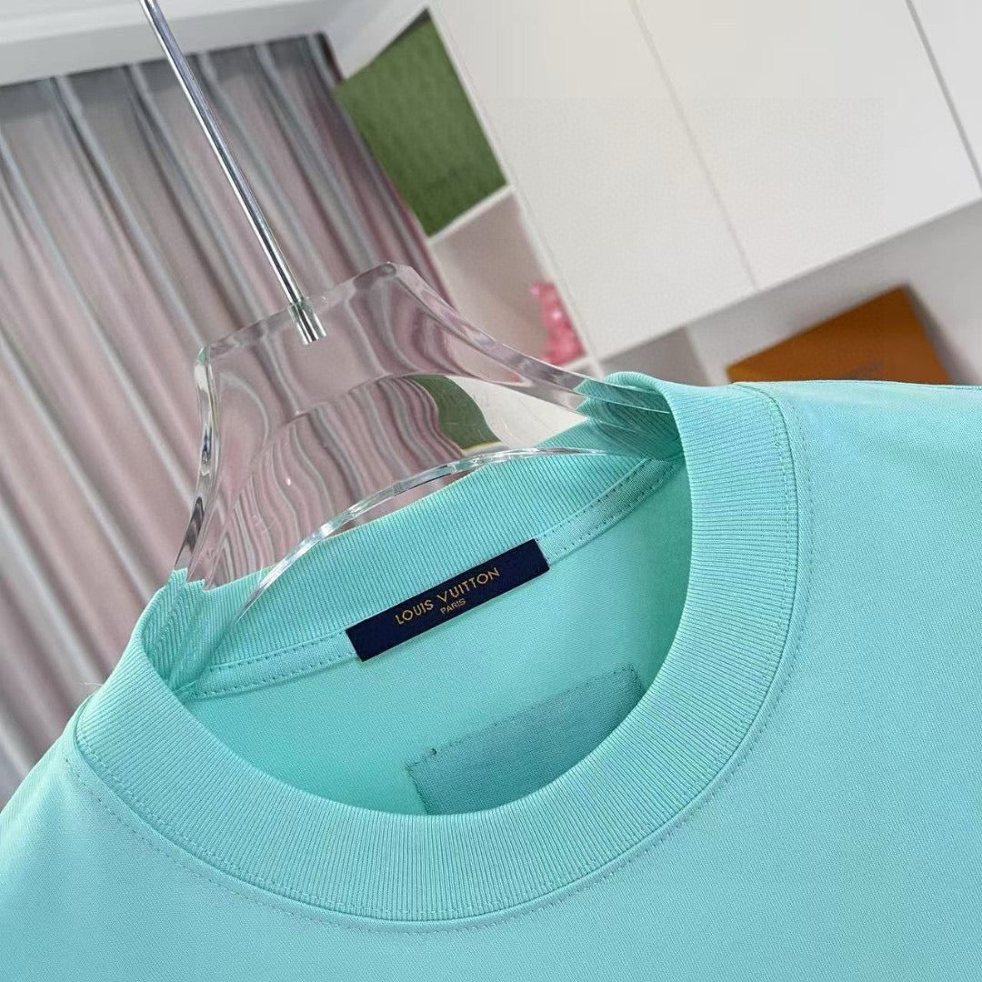 Turquoise crewneck T-shirt with interior neck label and ribbed collar trim