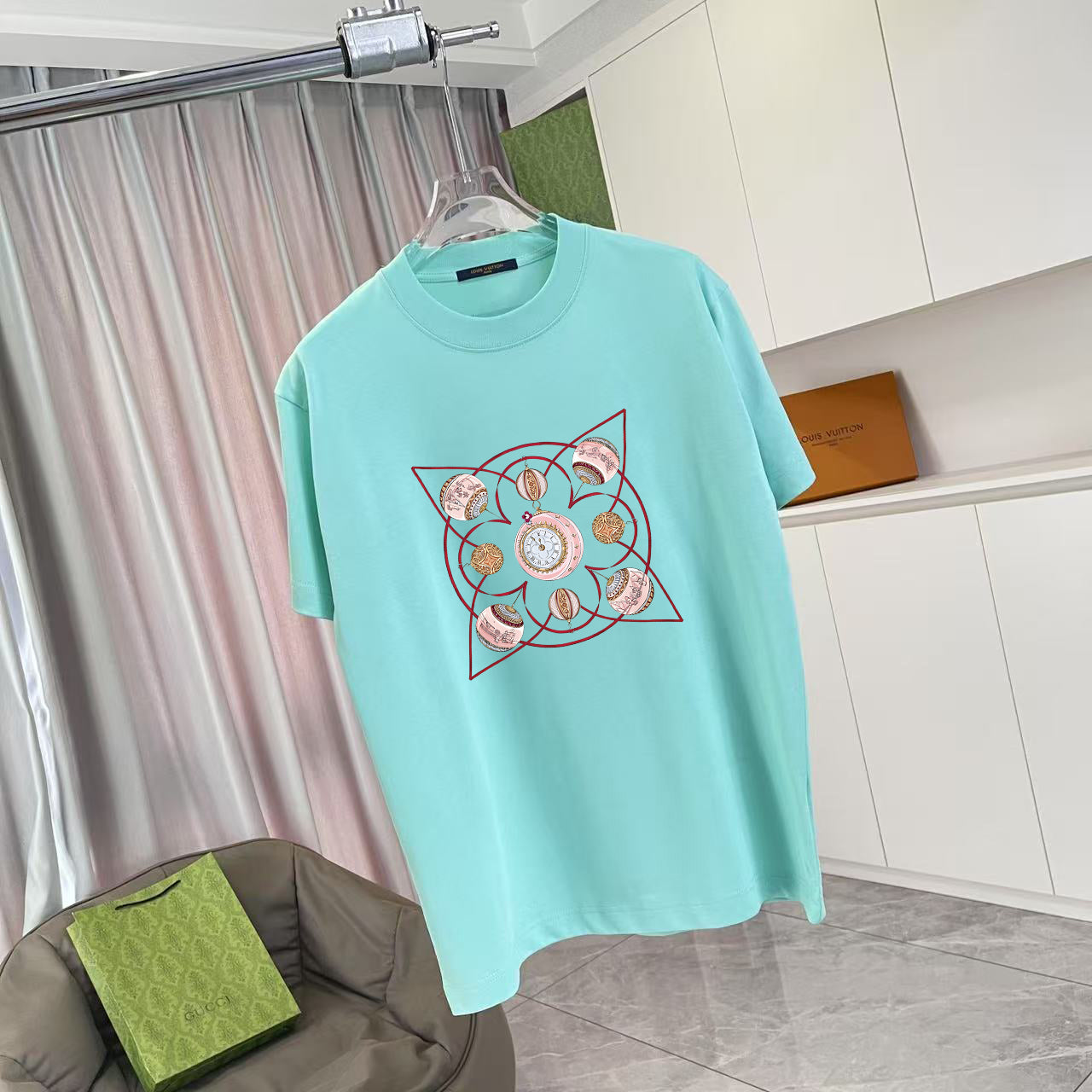 Turquoise crewneck T-shirt with centered multicolor emblem graphic on front
